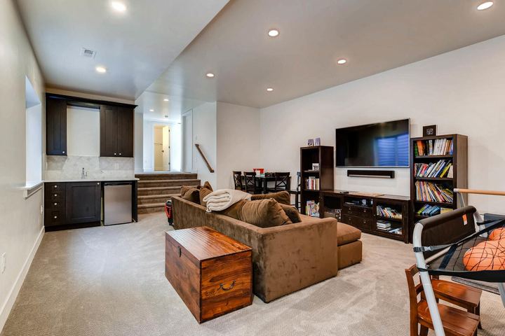 Lower Level Family Room of a Caliber custom home at 1379 S Lafayette St in Denver