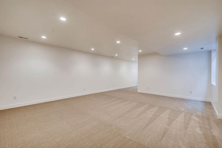 Lower Level Family Room of a Caliber custom home at 1442 S Clarkson St in Denver