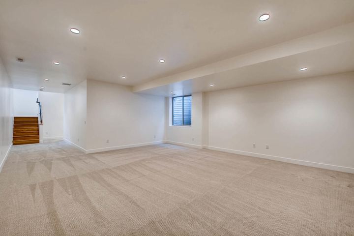 Lower Level Family Room of a Caliber custom home at 1442 S Clarkson St in Denver