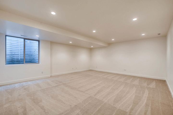 Lower Level Family Room of a Caliber custom home at 1442 S Clarkson St in Denver